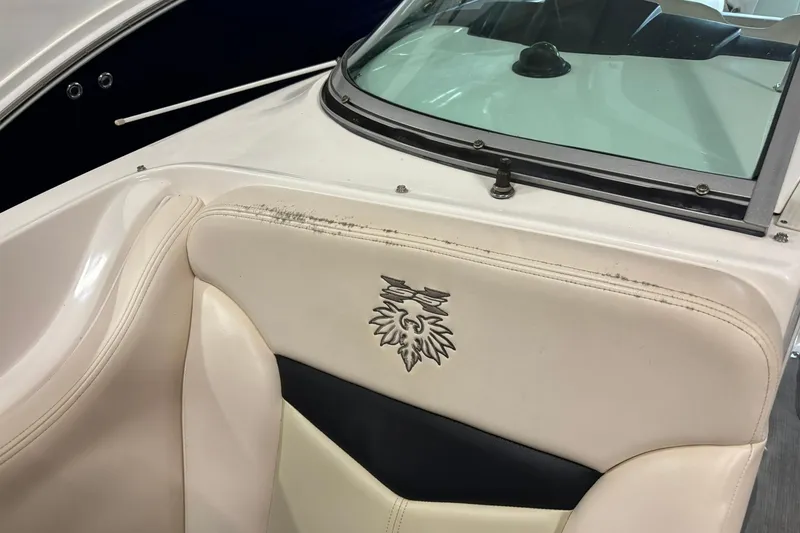 Slide: The Image of 2016 Chaparral 287 SSX boat interior with emblem on white leather seat. - 21