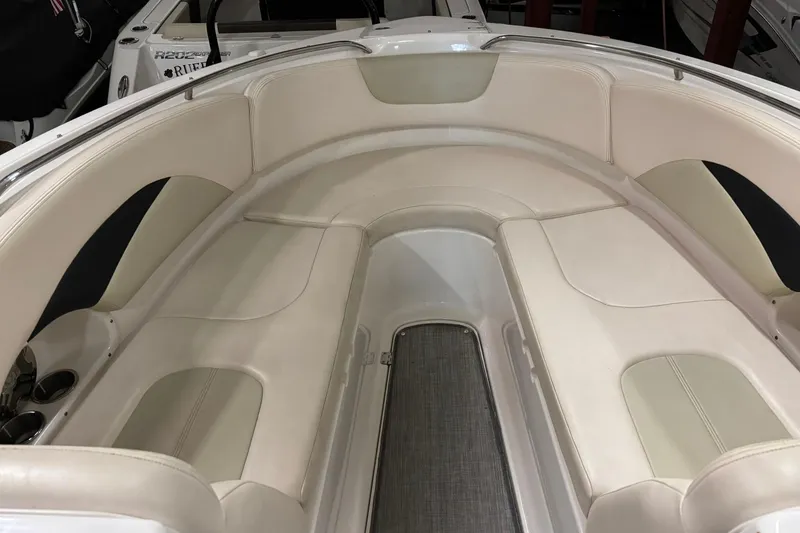 Slide: The Image of 2016 Chaparral 287 SSX boat interior with beige seating and sleek design. - 23