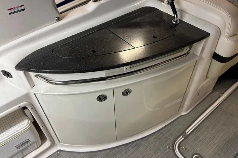 Slide: The Image of 2016 Chaparral 287 SSX boat interior with sleek countertop and storage cabinets. - 30