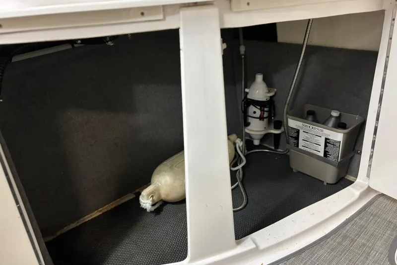 Slide: The Image of Storage compartment of 2016 Chaparral 287 SSX boat with equipment and supplies. - 31