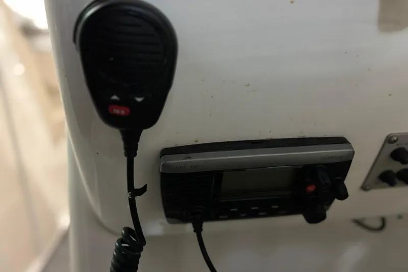 Slide: The Image of VHF radio and microphone on 2016 Chaparral 287 SSX boat dashboard. - 4