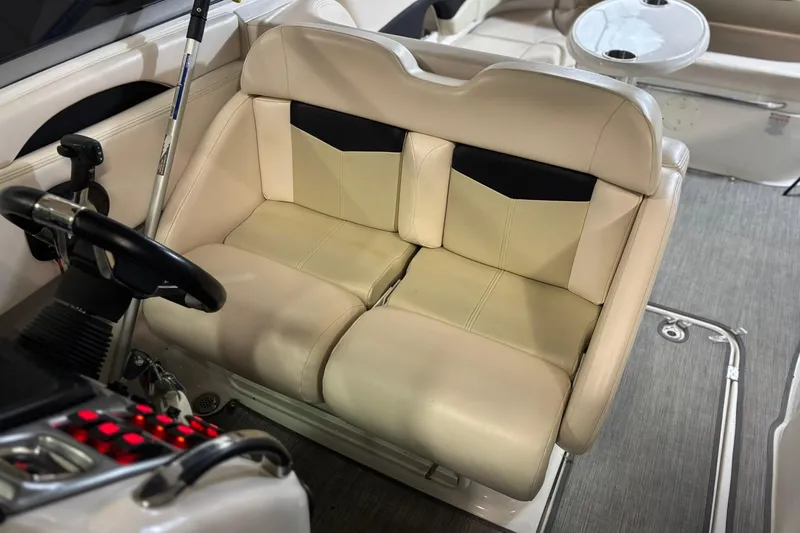 Slide: The Image of 2016 Chaparral 287 SSX boat interior with beige seating and steering wheel. - 5