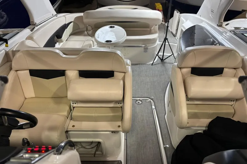 Slide: The Image of Interior of 2016 Chaparral 287 SSX boat with beige seating and table. - 7