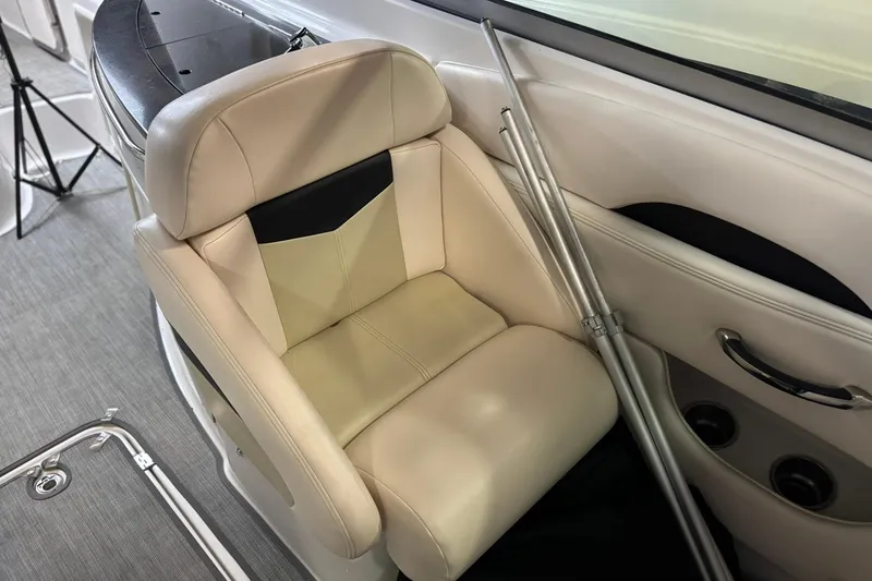 Slide: The Image of 2016 Chaparral 287 SSX boat interior with beige leather seat and metal poles. - 8
