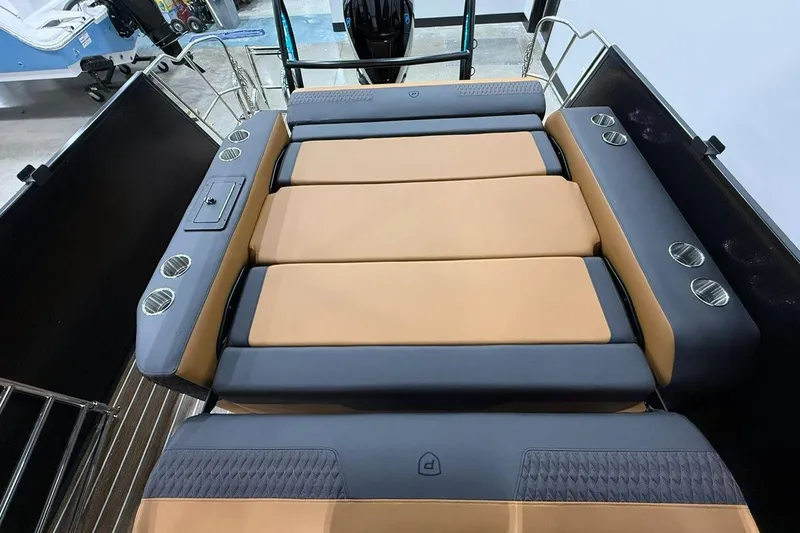 Slide: The Image of 2026 Premier 230 SOLARIS RL-CL boat interior with tan and gray seating, cup holders. - 11