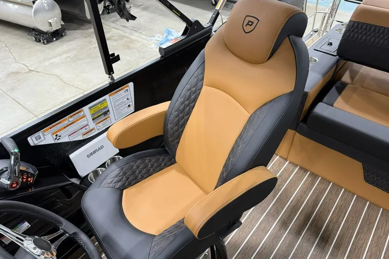Slide: The Image of Luxurious captain's chair in 2026 Premier 230 SOLARIS RL-CL boat, featuring tan and black upholstery. - 12