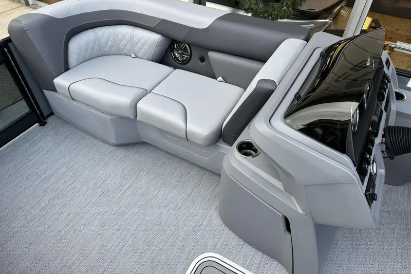 Slide: The Image of 2026 Godfrey Sweetwater 2286QS boat interior with gray seating and modern dashboard. - 6