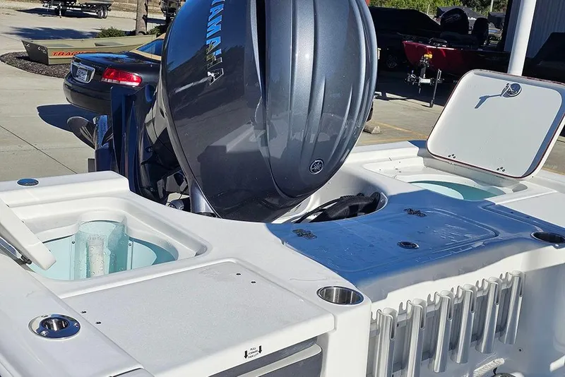 Slide: The Image of 2026 Sea Pro 210 Bay boat with Yamaha outboard engine, featuring livewell and storage compartments. - 11