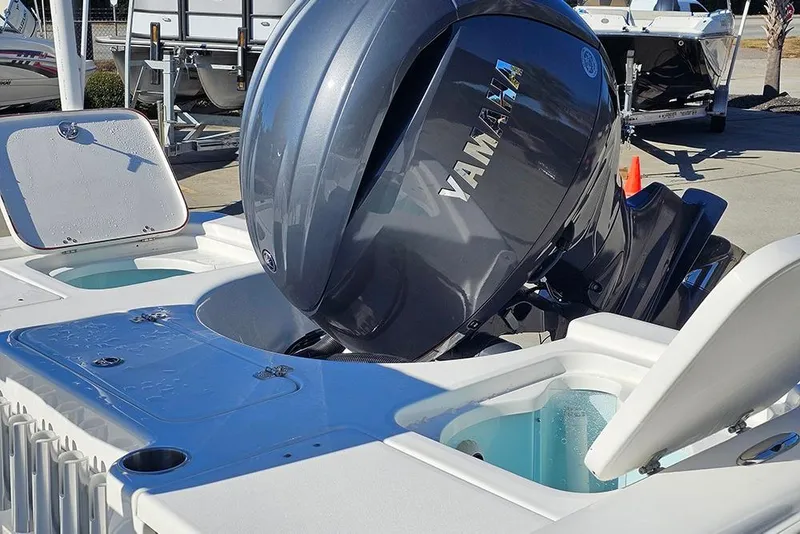 Slide: The Image of 2026 Sea Pro 210 Bay boat with Yamaha outboard engine, featuring open storage compartments. - 13