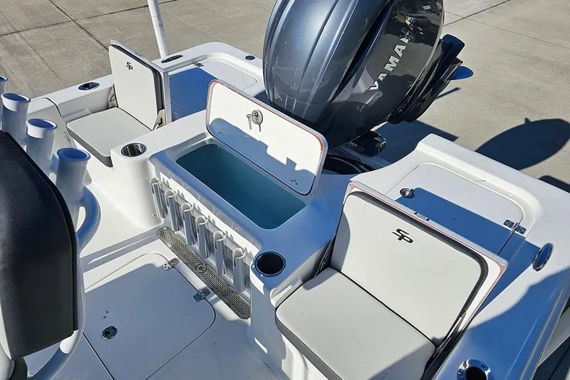 Slide: The Image of 2026 Sea Pro 210 Bay boat interior with Yamaha engine and storage compartments. - 14