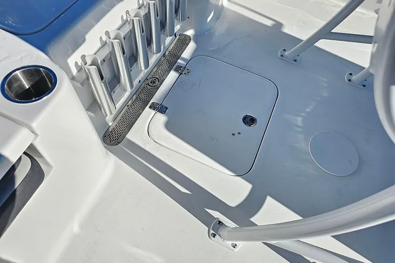 Slide: The Image of 2026 Sea Pro 210 Bay boat deck with rod holders and storage hatch. - 16