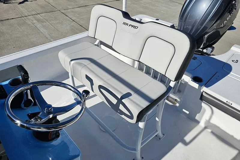 Slide: The Image of 2026 Sea Pro 210 Bay boat interior with steering wheel and seating. - 18
