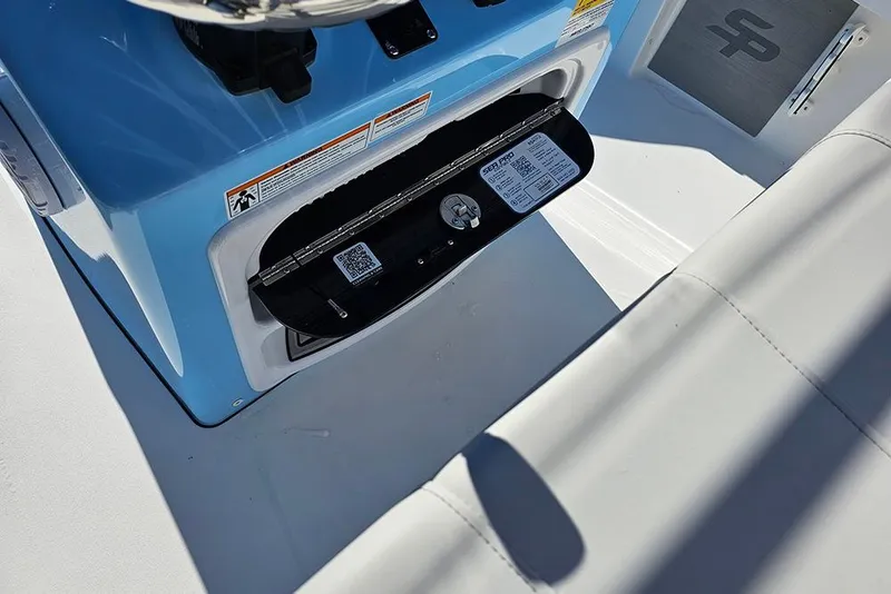 Slide: The Image of 2026 Sea Pro 210 Bay boat interior with open storage compartment and QR code. - 20