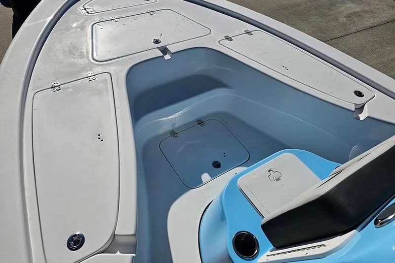 Slide: The Image of 2026 Sea Pro 210 Bay boat interior with storage compartments and seating. - 22