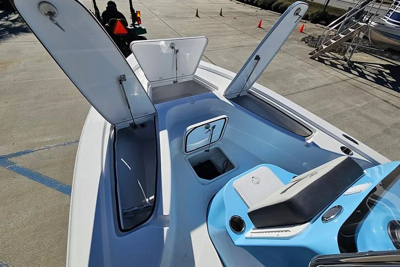 Slide: The Image of 2026 Sea Pro 210 Bay boat interior with open storage compartments and seating. - 23