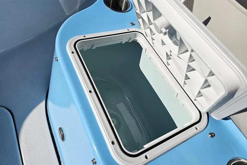Slide: The Image of Open storage compartment on 2026 Sea Pro 210 Bay boat, featuring a light blue interior. - 25