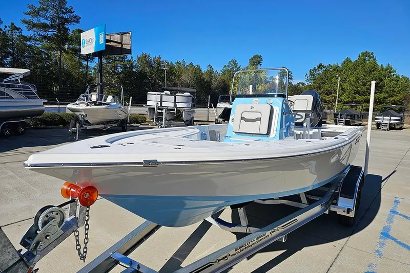 Slide: The Image of 2026 Sea Pro 210 Bay boat on trailer in outdoor dealership setting. - 5