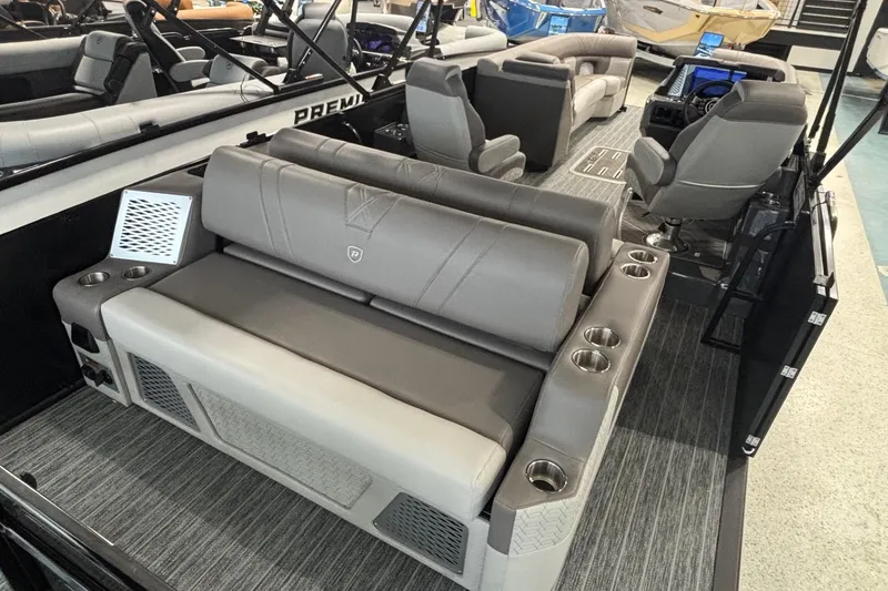 Slide: The Image of 2026 Premier 250 Intrigue RLO-CL pontoon boat interior with luxurious seating and cup holders. - 12