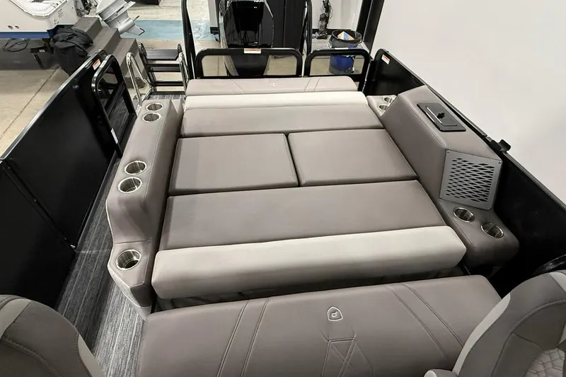 Slide: The Image of 2026 Premier 250 Intrigue RLO-CL boat interior with cushioned seating and cup holders. - 13