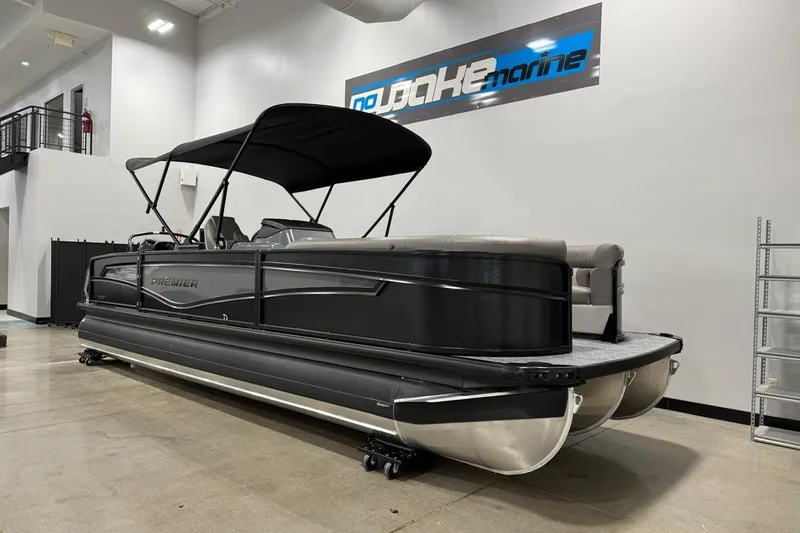 Slide: The Image of 2026 Premier 250 Intrigue RLO-CL pontoon boat in showroom with black canopy. - 3