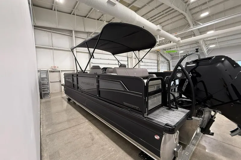 Slide: The Image of 2026 Premier 250 Intrigue RLO-CL pontoon boat in a spacious indoor showroom. - 4