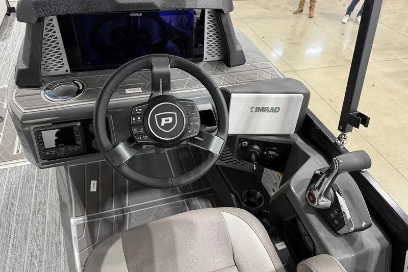 Slide: The Image of 2026 Premier 250 Intrigue RLO-CL boat dashboard with steering wheel and controls. - 7