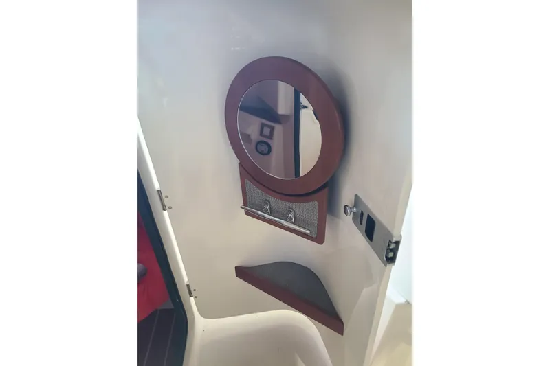 Slide: The Image of Interior of 2017 Grady-White Freedom 235 boat with mirror and storage shelf. - 13