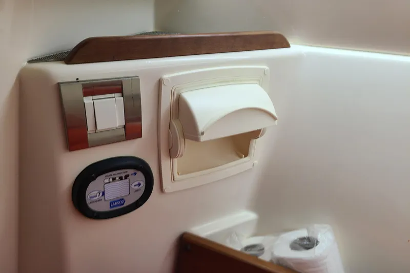 Slide: The Image of Control panel and storage area inside 2017 Grady-White Freedom 235 boat cabin. - 16