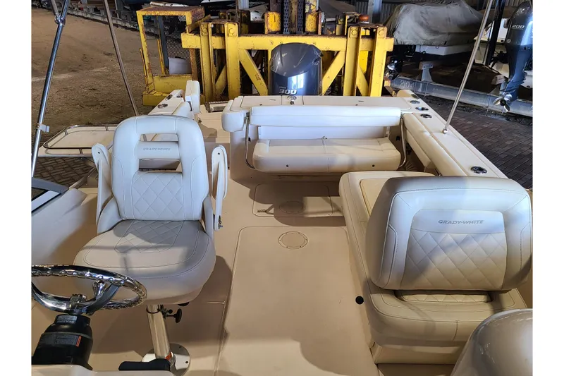 Slide: The Image of 2017 Grady-White Freedom 235 boat interior with seating and steering wheel. - 18