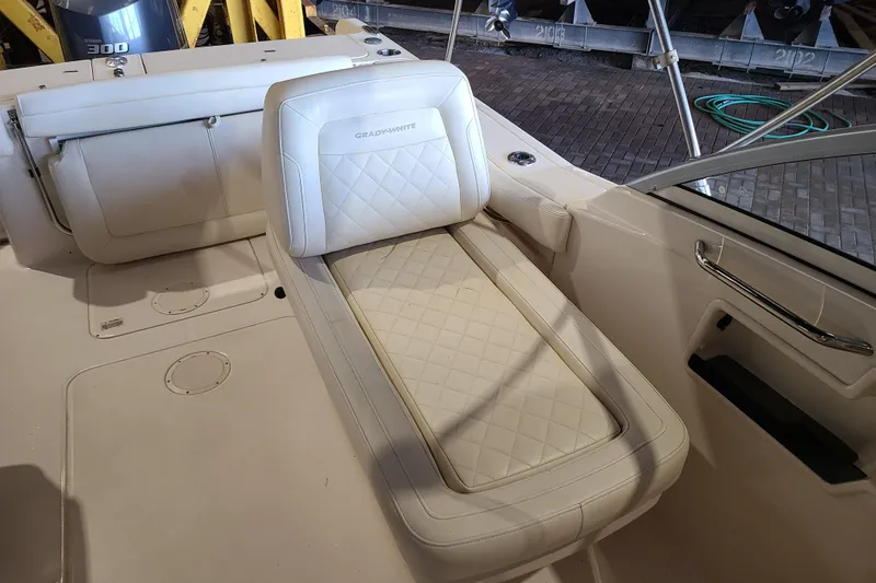 Slide: The Image of 2017 Grady-White Freedom 235 boat interior with cushioned seating and sleek design. - 20
