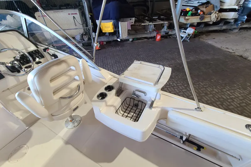 Slide: The Image of 2017 Grady-White Freedom 235 boat interior with helm seat and storage area. - 21