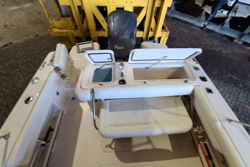 Slide: The Image of 2017 Grady-White Freedom 235 boat interior with open storage compartments and seating. - 22