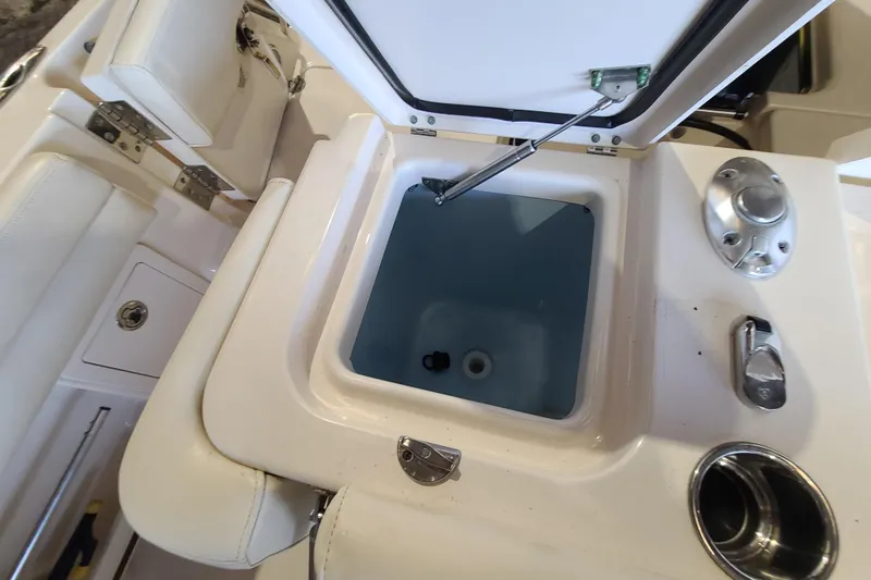 Slide: The Image of 2017 Grady-White Freedom 235 boat interior with open storage compartment. - 23