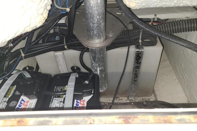 Slide: The Image of Battery compartment of a 2017 Grady-White Freedom 235 boat, showing wiring and connections. - 26