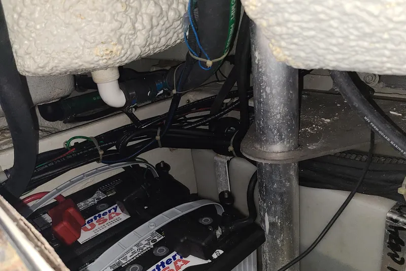 Slide: The Image of 2017 Grady-White Freedom 235 boat interior showing battery and wiring setup. - 27