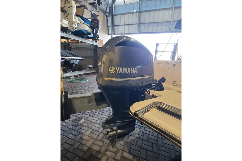 Slide: The Image of 2017 Grady-White Freedom 235 with Yamaha outboard motor in storage facility. - 28