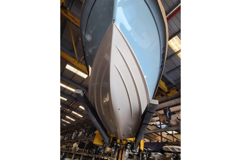 Slide: The Image of 2017 Grady-White Freedom 235 boat hull in a warehouse setting. - 35