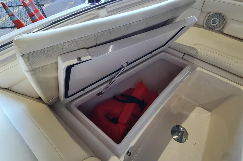 Slide: The Image of Storage compartment on 2017 Grady-White Freedom 235 boat with life jackets inside. - 4