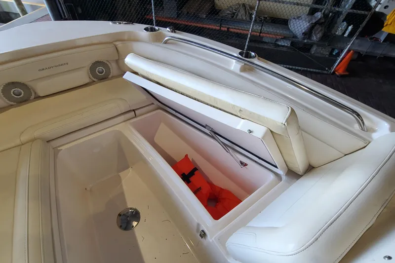 Slide: The Image of 2017 Grady-White Freedom 235 boat interior with storage compartment and life jacket. - 5