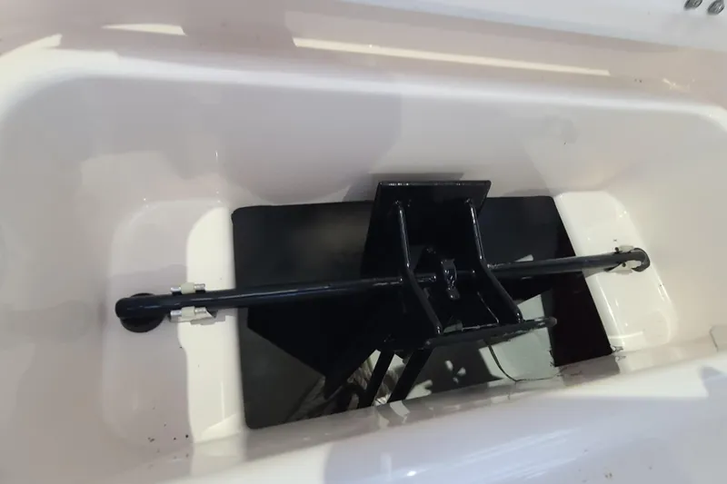 Slide: The Image of 2017 Grady-White Freedom 235 boat anchor compartment, featuring a black anchor and rod. - 6