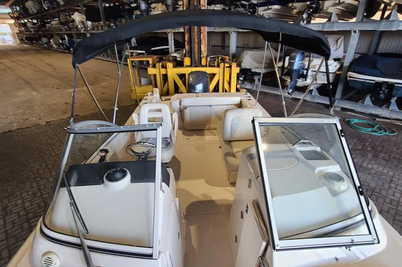 Slide: The Image of 2017 Grady-White Freedom 235 boat with open deck and canopy in storage facility. - 7