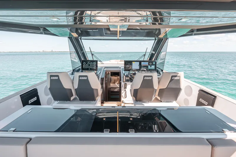 Slide: The Image of 2026 Fjord 490 SPORT luxury yacht interior with modern helm and ocean view. - 10