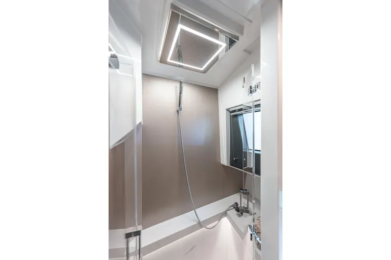 Slide: The Image of Modern shower area in 2026 Fjord 490 SPORT yacht, featuring sleek design and overhead lighting. - 14