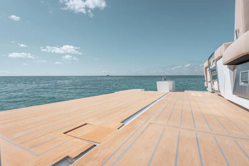 Slide: The Image of 2026 Fjord 490 SPORT yacht deck overlooking serene ocean view. - 18