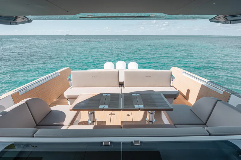 Slide: The Image of Luxury seating area on 2026 Fjord 490 SPORT yacht overlooking serene ocean. - 19