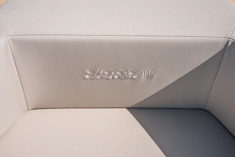 Slide: The Image of Fjord 490 SPORT 2026 boat seat with embossed logo on beige upholstery. - 27