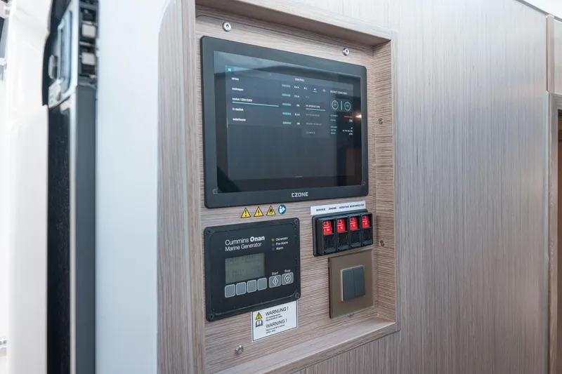 Slide: The Image of Control panel of 2026 Fjord 490 SPORT with touchscreen and marine generator display. - 28