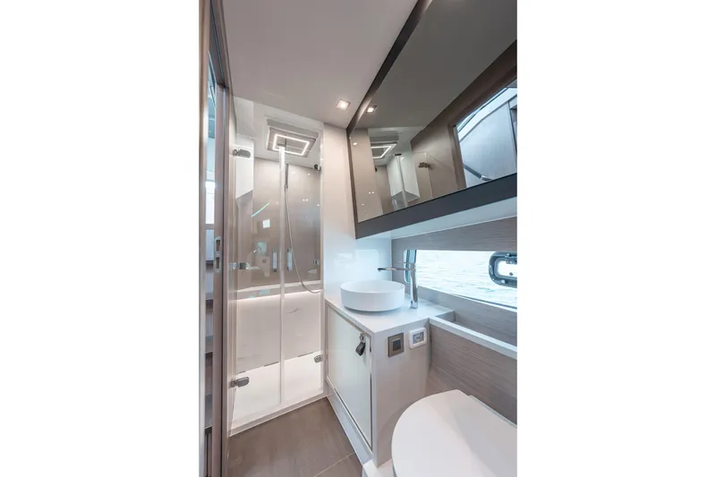 Slide: The Image of Luxurious bathroom in 2026 Fjord 490 SPORT yacht with modern fixtures and ocean view. - 29