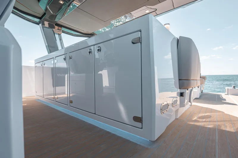 Slide: The Image of 2026 Fjord 490 SPORT yacht interior with sleek cabinetry and ocean view. - 31