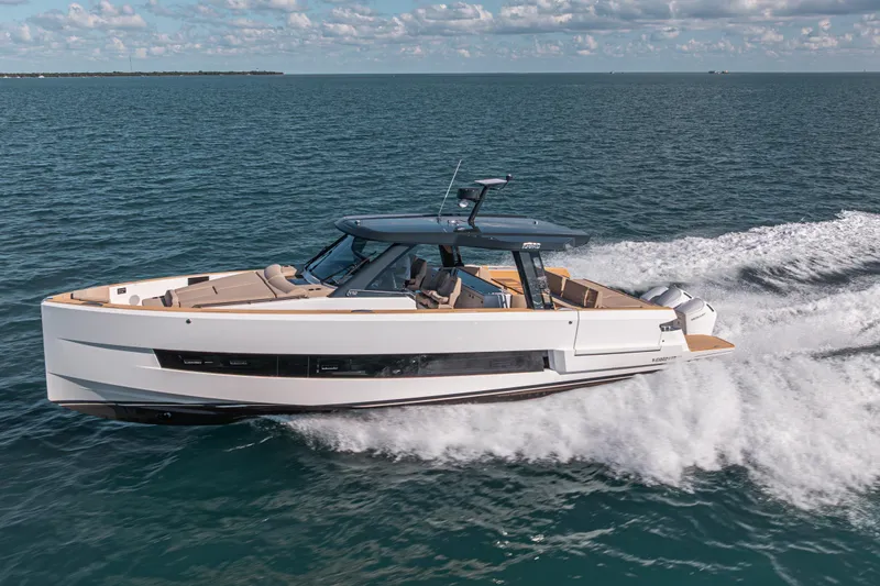 Slide: The Image of 2026 Fjord 490 SPORT yacht cruising on open water under a partly cloudy sky. - 3